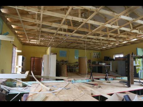 Work under way to repair the roof of the library and computer lab at Pedro Plains Primary School in St Elizabeth last Friday.