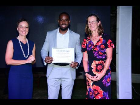 Senator Kamina Johnson Smith, minister of foreign affairs and foreign trade, and Judith Slater, British high commissioner to Jamaica, present Sayeed Bernard with his certificate of acceptance at the 2024 Chevening Scholarship Award Ceremony and Reception.