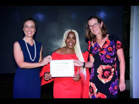 Senator Kamina Johnson Smith (left), minister of foreign affairs and foreign trade, and Judith Slater, British high commissioner to Jamaica, present Jomarie Malcolm Gordon with her certificate of acceptance at the 2024 Chevening Scholarship Award Ceremony 