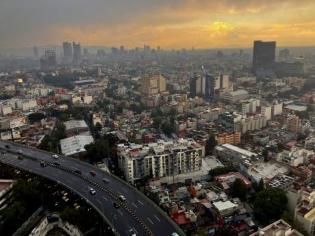 The sun sets in Mexico City after heavy rain on July 25, 2024.