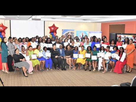 Hilary Coulton (left, seated), public relations and administrative manager of the CHASE Fund; Ian Forbes (centre, seated), custos rotulorum of St Andrew and board member of United Way of Jamaica; and Taneshia Stoney Dryden (centre right, seated), CEO of Un