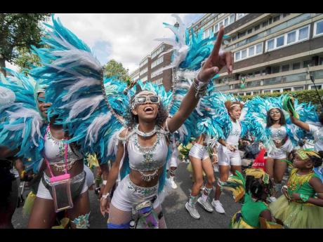 Revelry on the road at the Children’s Day Parade, part of the Notting Hill Carnival celebration in west London. 