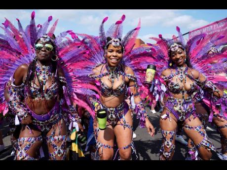 Dancers prepare to take part in the Notting Hill Carnival celebration in west London, Monday.