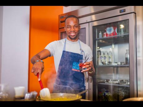 Gordon’s Gin Junior Brand Manager Lasana Wilson preparing the cream yam and potato ragout while having a glass of Gordon’s Premium Pink Gin in hand.