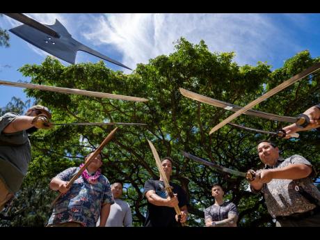 Members of Hawaii Firearms Coalition showcase their halberd, swords and balisong at Kapiolani Park on Saturday, June 22, 2024, in Honolulu, Hawaii. 