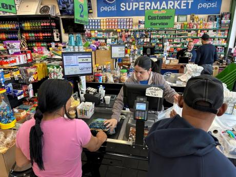 Cashier Rosa Dilone helps customers at Mi Tierra Supermarket in Hazleton, Pennsylvania, on May 16, 2024.