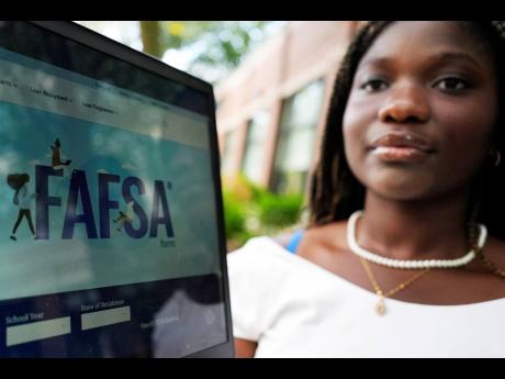 FAFSA website is seen on the laptop as Adjovi Golo holds a laptop at DePaul University in Chicago.