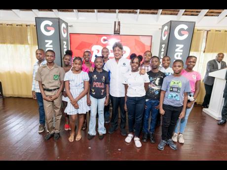  Kenneth Benjamin, chairman of Guardsman Group (centre), with scholarship awardees.