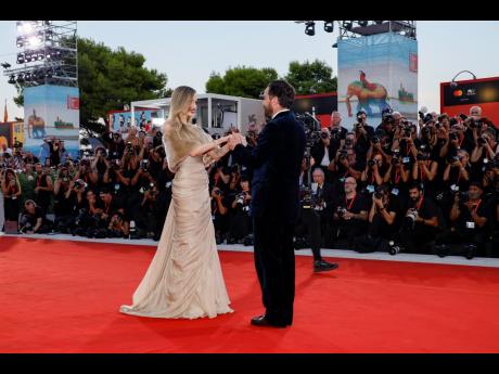 Angelina Jolie and director Pablo Larrain walk the red carpet during the 81st edition of the Venice Film Festival in Venice, Italy on Thursday.