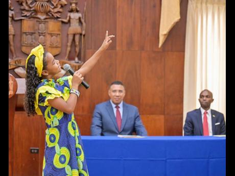 Malia Brown performs an item during an awards ceremony held at Jamaica House in St Andrew  yesterday for children of employees of the Office of the Prime Minister and the Cabinet Office who were successful in the Primary Exit Profile examinations held earl