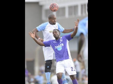 Action from a previous edition of the Roper Cup. Pictured are St George’s College’s Kwame Livermore (left) and Kingston College’s Errol Lewis.