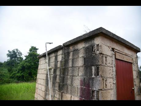 A pipe that usually carries water from the tanks to the taps at New Broughton Primary School stood alone last week, awaiting the tanks to restore the connection.