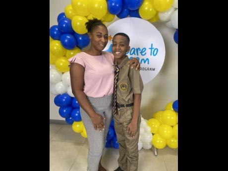 Jaden Henry and his mother, Nyaesha Heholt, after collecting his scholarship on Friday at Unicomer’s head office in Kingston.