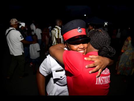 Constable Natoya Turnbull (right), firearms instructor in the Jamaica Constabulary Forces, embraces her sister, Constable Dedranae Turnbull, after the latter’s graduation at the Jamaica Constabulary Force’s passing-out parade held last Wednesday at the