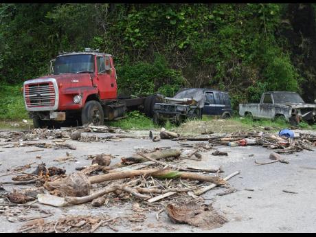 Main road filled with debris from the flood caused by heavy rainfall in John’s Hall in St James.