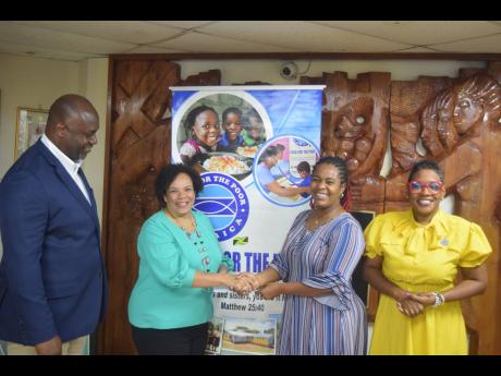 President of the Shipping Association of Jamaica Corah Ann Robertson-Sylvester (second left) presents a cheque to Food For The Poor’s Executive Director Kivette Silvera Stephens to assist with Hurricane Beryl relief efforts. Sharing the moment are SAJ De