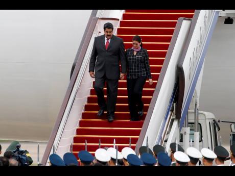 Venezuela’s President Nicolas Maduro and First Lady Cilia Flores arrive at Beijing Capital International Airport in Beijing, China, on Sepember 1, 2015.