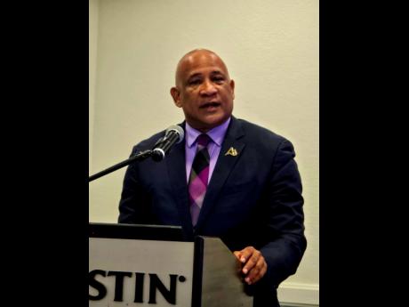 Deputy Prime Minister and Minister of Tourism Dr Ernest Hilaire addressing the media during the State of the Tourism Industry Conference  2024 at the Westin Grand Cayman.