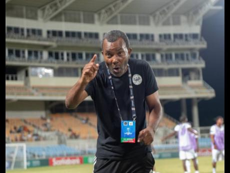 Rudolph Speid speaks to his charges during a Concacaf Caribbean Cup game between Cavalier and Police FC at Sabina Park last week.