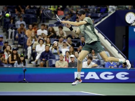 Jannik Sinner, of Italy, returns a shot to Tommy Paul, of the United States, during a US Open fourth-round match on Monday.