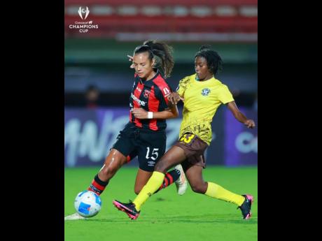 Alajuelense’s Stephannie Blanco tries to go past the outstrestched leg of Frazsiers Whip’s Suen Gregory during their Concacaf Women’s Champions Cup at the Estadio Alejandro Morera Soto in Costa Rica last Tuesday. 