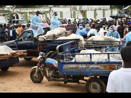 Bodies of people killed by suspected Boko Haram Islamist extremists are transported for burial, in Tarmuwa, northeast Nigeria, yesterday.