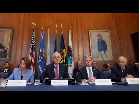 Attorney General Merrick Garland (second left), speaks before a meeting of the Justice Department’s Election Threats Task Force, at the Department of Justice, in Washington, with Deputy Attorney General Lisa Monaco (left), FBI Director Christopher Wray, 