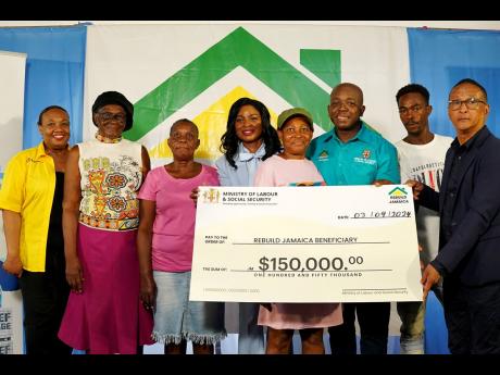 Labour ministry officials and beneficiaries share in a photo at the ceremony for the presentation of a symbolic cheque of $150,000 to residents of St Thomas impacted by Hurricane Beryl. From left: Audrey Deer Williams, chief technical director for the Soci