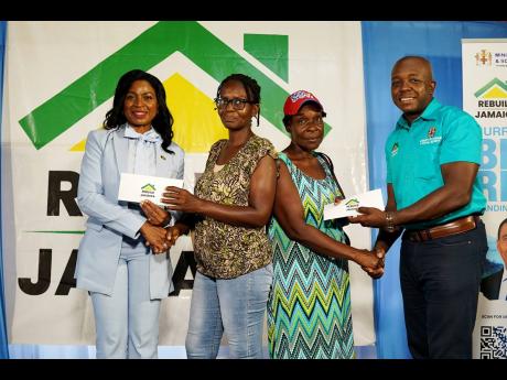 Beneficiaries of the Rebuild Jamaica Initiative proudly receive their cheques during the official handover at the Morant Villas Hotel on Tuesday, September 3. From left are: Dr Michelle Charles, member of parliament for St Thomas Eastern; Shellion Bogle; L