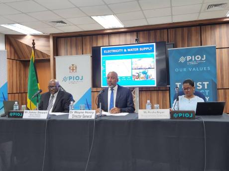 Contributed 
Director General of the Planning Institute of Jamaica (PIOJ), Dr Wayne Henry (centre), speaks during the agency’s June 2024 quarterly media briefing on Wednesday. Listening (from left) are PIOJ Senior Director, Economic Planning and Research