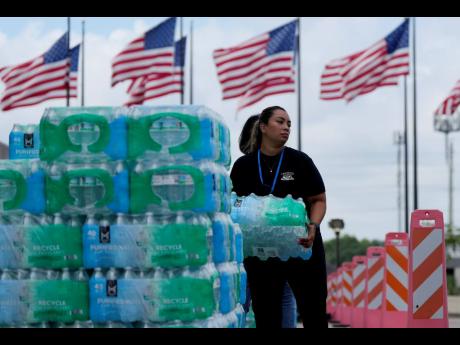 Staff at Lakewood Church hand out water and operate a cooling station in Houston, Texas on July 9.