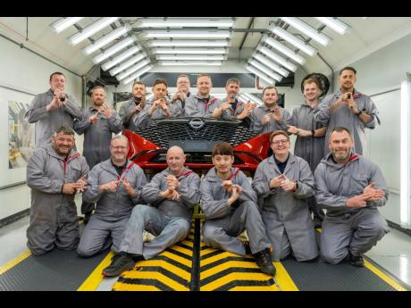 Workers of Nissan’s plant’s Paint Shop pose for a photo at the plant, in Sunderland, England.