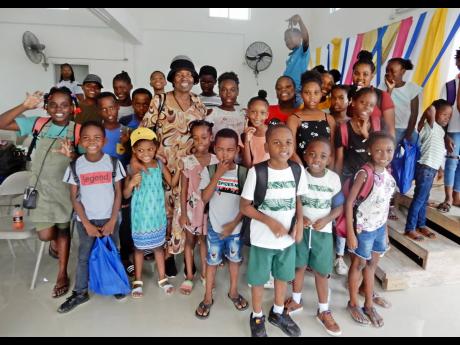 
Pastor Albertha Boswell James with some of the children who came out for the back-to-school treat held at the church recently.