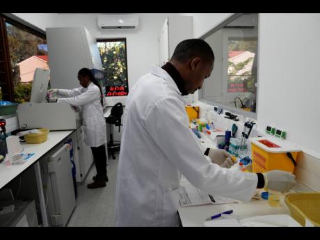 AP 
Lab technician Xolile Mhlanga works with vials of lenacapavir at the Desmond Tutu Health Foundation’s Masiphumelele Research Site, in Cape Town, South Africa.