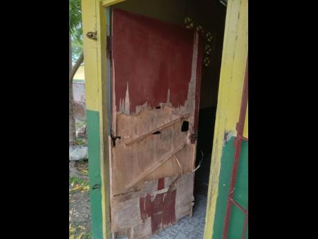 A weather-beaten, termite-ravaged door at Tulloch Primary. Several pieces of wooden furniture and fixtures at the school are falling apart due to termite infestation.