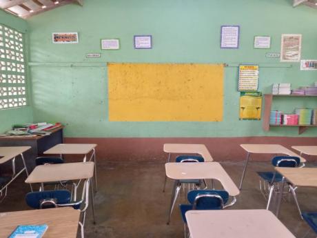 The whiteboard in this classroom is one of at least eight that need to be replaced after they were eaten by termites.