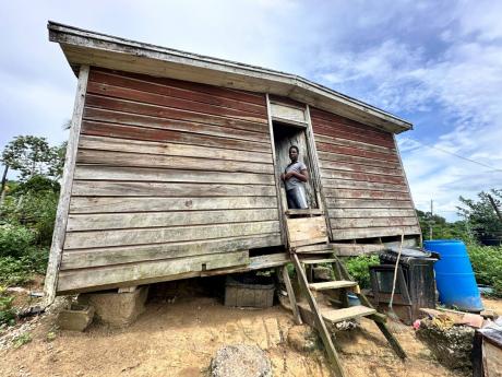 
Fourteen-year-old Antwone Stewart, who was diagnosed with intellectual disability, looks out from the one-bedroom rental wooden shack he shares with his mother Janice Jenkins and sister in Somerton, St James. 