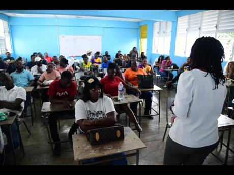 Principal Monique Grant-Facey addresses staff at the Happy Grove High School in Portland during a staff meeting held at the Hector's River-based school last Wednesday.