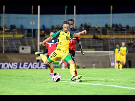 
Reggae Boy midfielder Bobby Reid takes a shot at goal ahead of Cuban counterpart Alejandro Delgado, during a Concacaf Nations League A Group B fixture at the National Stadium on Friday night.