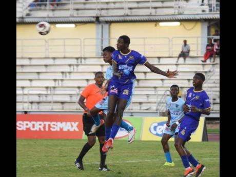 
Denbigh High School’s Devor Wyner (left) challenges Clarendon College’s Romario Thompson (centre) for a header during their opening Group H daCosta Cup fixture at the Montego Bay Sports Complex yesterday.