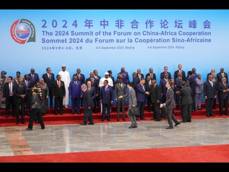 China’s President Xi Jinping (center right) shakes hands with leaders from African countries as they arrive for a group photo session before the opening ceremony of the China-Africa Forum at the Great Hall of the People in Beijing, on September 5, 2024.