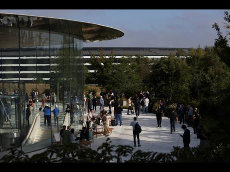 Attendees wait inside and outside the Steve Jobs Theater before an announcement of new products at Apple’s headquarters on Monday, September 9, 2024, in Cupertino, California.