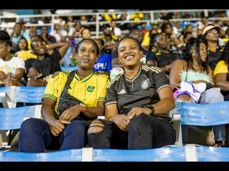 Former Reggae Girlz Alicia James (left) and Tashana Vincent were checked in for the Jamaica vs Cuba game last Friday.