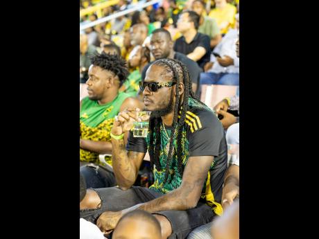 Dancehall star Aidonia watches the play attentively.