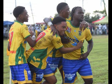 Rusea’s High School players celebrate a goal during their ISSA daCosta Cup schoolboy football match against Cambridge High School at the Collin Miller Sports Complex yesterday.