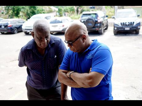 M&M Jamaica’s senior project manager, David Foster, has South Eastern St Elizabeth’s Member of Parliament Witter’s rapt attention as he discusses restoration planning for St Elizabeth. 