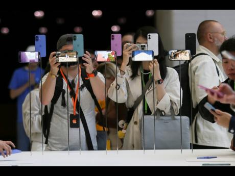 
Attendees take a closer look at the Apple iPhone 16 during an announcement of new products at Apple headquarters Monday, September 9, 2024, in Cupertino, California. The European Union’s top court rejected Apple’s final legal challenge against an orde