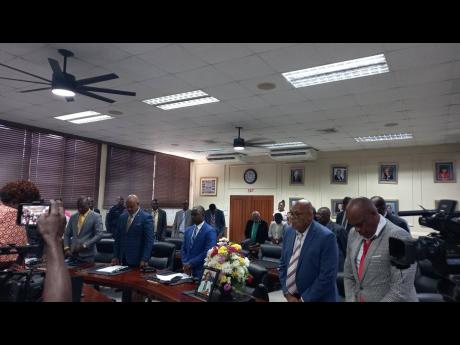 Councillors pay their respects to Marjorie McLeod-McFarlane during the September 12 sitting of the Clarendon Municipal Corporation. McLeod-McFarlane, the councillor for the Aenon Town division, died just over a week ago. 