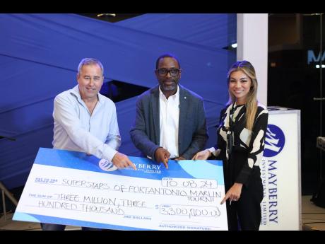 Robert ‘Bobby’ Stewart (left) tournament director for the  Superstars of Port Antonio International Marlin Tournament collects a sponsorship cheque from Dan Theoc (centre), senior vice-president of investment banking, Mayberry Investment and Stephanie 