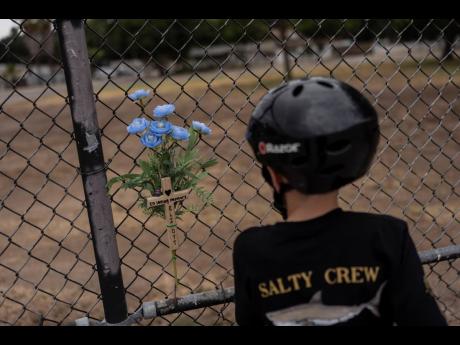 Jax Brown, half-brother of Elijah Ott, who died of a fentanyl overdose at 15, looks at a memorial for Elijah at a skateboard park in Paso Robles, California, on August 2.